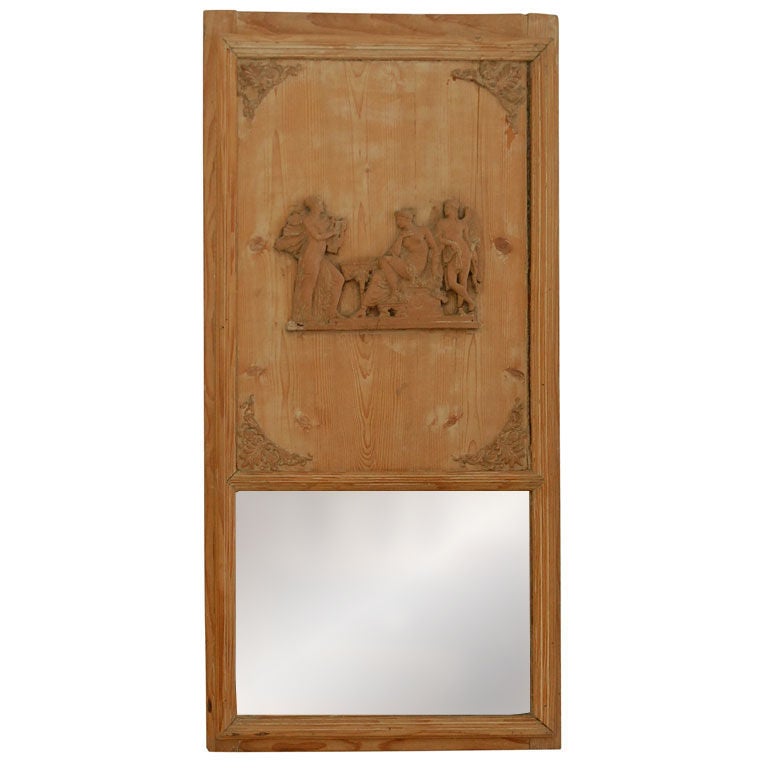 Pine directoire trumeau from France circa 1820. The rectangular fluted frame encloses the trumeau top with scrolled foliate motif corners and a beautiful neoclassical frieze of a seated goddess flanked by a winged male figure and woman playing a