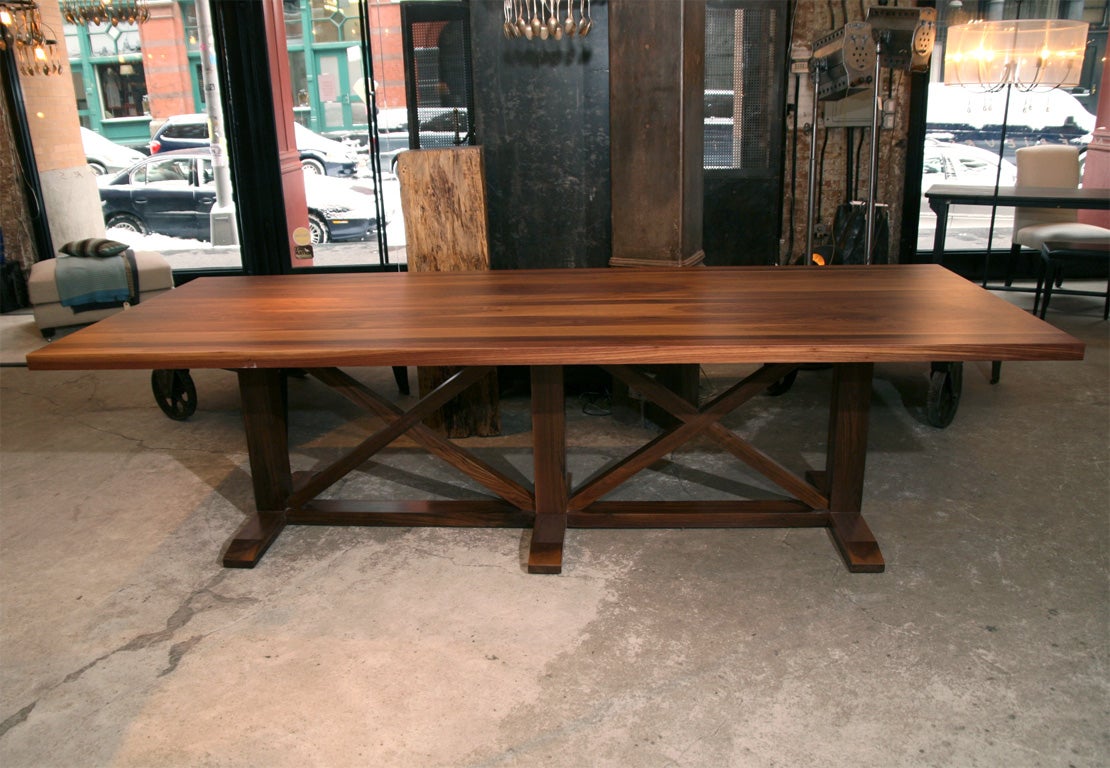 Hand made solid walnut dining table with a flat cut plank top and x form base. Custom sizes available, please inquire.