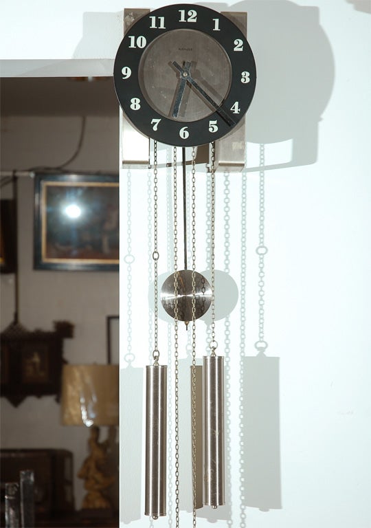 A German wall clock, circa 1930's, eight day, weight driven on chains, chimes on the hour and half hour, exposed pendulum. A good clock, well made and ready to keep you on time.<br />
Jefferson West Antiques offer a selection of clocks, furniture,