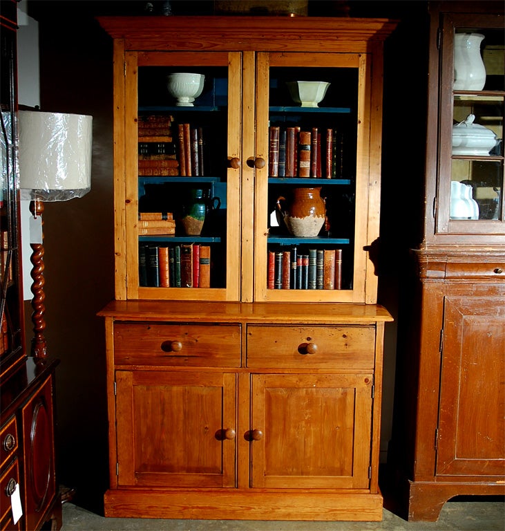 This Cabinet is thought to be English and from the 19th century. The top section has two glazed doors and allows for lots of books or other items to be displayed. Two good sized drawers give plenty of useful space and the large enclosed area at the