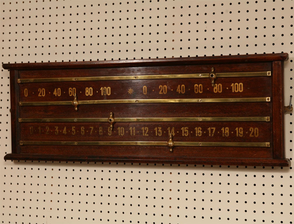 This original pool scoreboard is in dark grain wood with shiny brass rails and sliding finials. It is a terrific piece of art, unless you have a pool table and enjoy the game. A unique piece in splendid condition.
