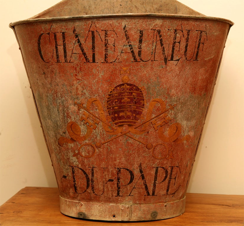 Metal original paint with great patina and the Chateauneuf de-Pape vineyard code of arms onre on this beautiful grape hotte, used to pick grapes in the south of France