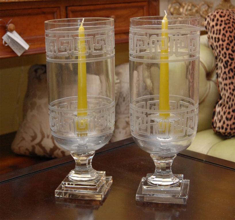 Striking Hurricane candle holders of etched glass with Greek Key motif. There is a glass candle stick in the center of each Hurricane to hold tapers securely. Chartreuse candles are available for sale.