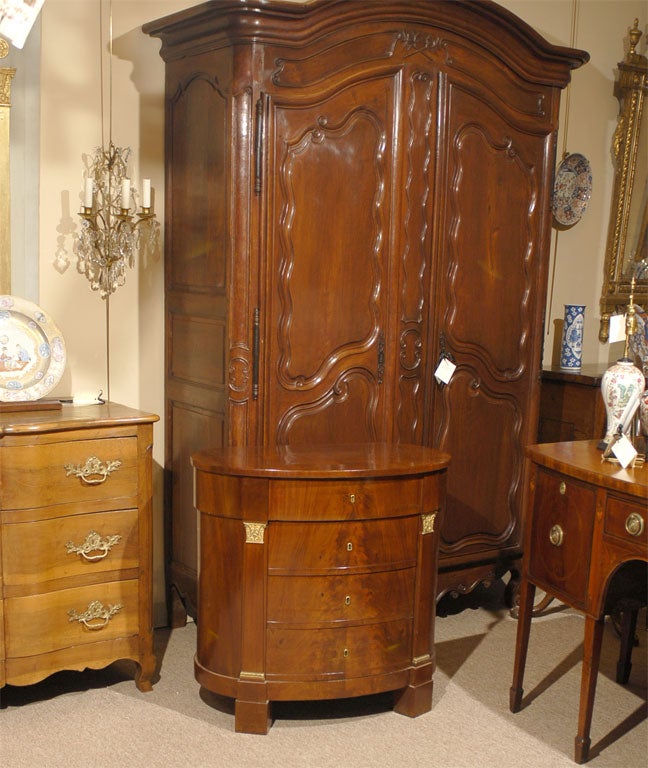 A fine Empire period Cellarette of oval form, with a rich Mahogany exterior accented by Gilt-Bronze mounts. Originating in France, and dating from the first half of the 1800s. 

The oval body with a lift-top compartment, and a set of three sliding