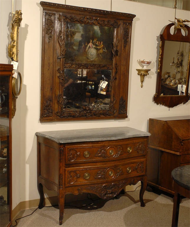 A fine Walnut Commode of serpentine form. Originating in the Provence region of France, and dating from the Louis XV period. Notable for its pierced apron and deep carved designs, and for retaining its original striated marble top.

The body with