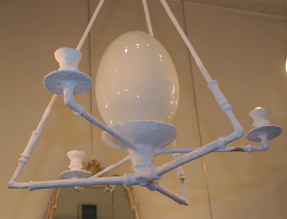 A plaster covered metal chandelier