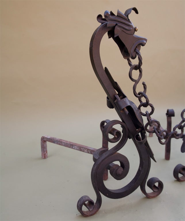Pair of impressive wrought iron dragon andirons with original wrought iron chain. The finish is all original.