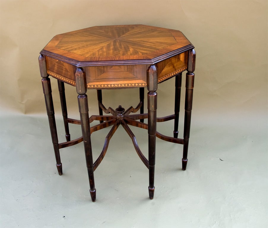 Rich inlaid table with fruitwood. 8 leg construction.
