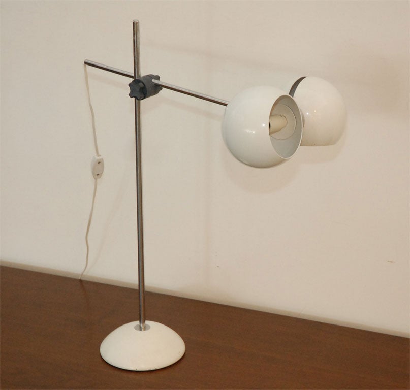 Simple desk light designed by Gae Aulenti in original white painted globes and base.  Lights pivot and height can be adjusted.