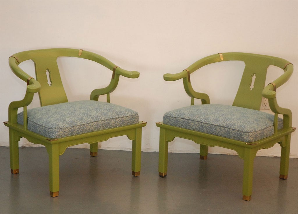 Pair of Asian chairs in the style of James Mont lacquered canary lime green with elegant blue upholstry. Great Hollywood regency style. Brass detailing.