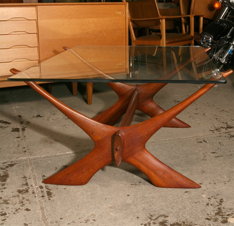 Unusual 'X' base coffee table in polished teak by Danish modern designer, Illum Wikkelso. Wikkelso studied under Jacob Kaer and opened his own studio in l954. Manufactured by C. F. Christensen.