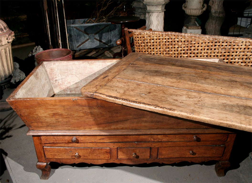 Exceptionally large early 19th century French petrin (dough box) from near Lyon. Of walnut construction with pine secondary wood, the loose lid top sits on slanted sides and dovetailed box which is supported by the base with scalloped apron, and one