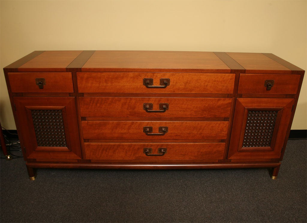 REDUCED FROM $3,850....Very fine Bert England sideboard in two tone walnut. Features warm figured walnut framed with dark walnut belting and sides. Striking antiqued brass handles and pulls and brass sabots. Four large centre drawers, two smaller