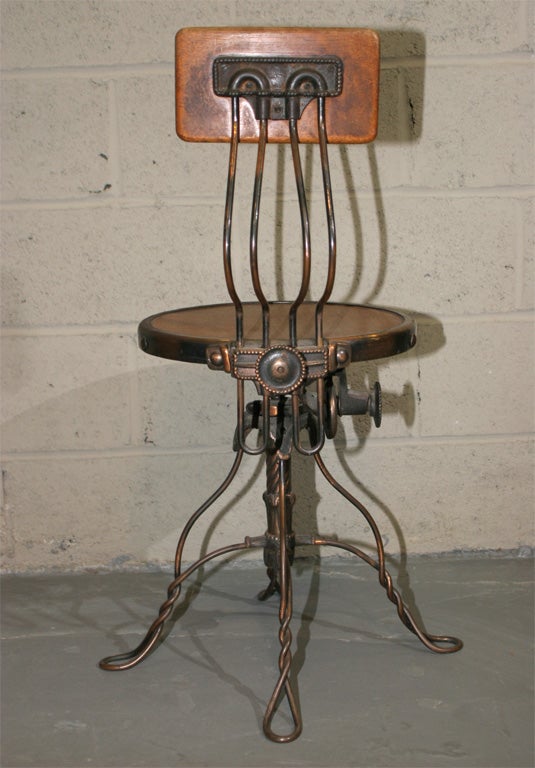 An America twisted steel and wood sewing chair, adjustable height and back rest with a swivel seat. Isaac Merrit Singer, Boston - Patent 1851?