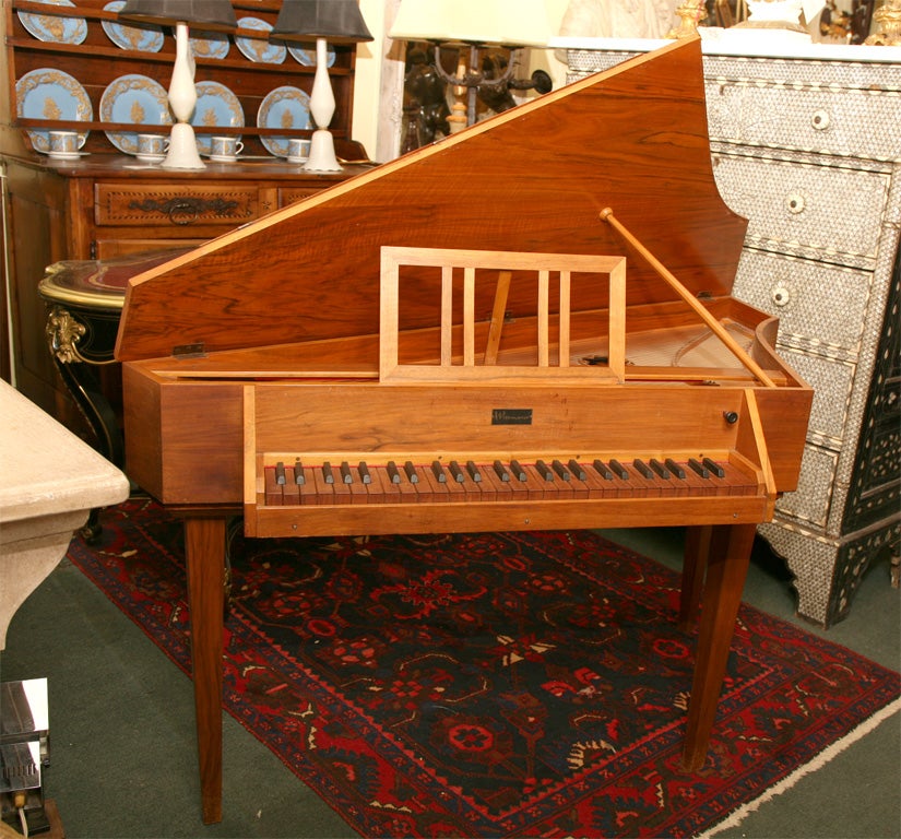 A VERY UNUSUALLY SHAPED INSTRUMENT TO SAY THE LEAST WITH WOODEN KEYS THAT PLUCK RATHER THAN STRIKE.