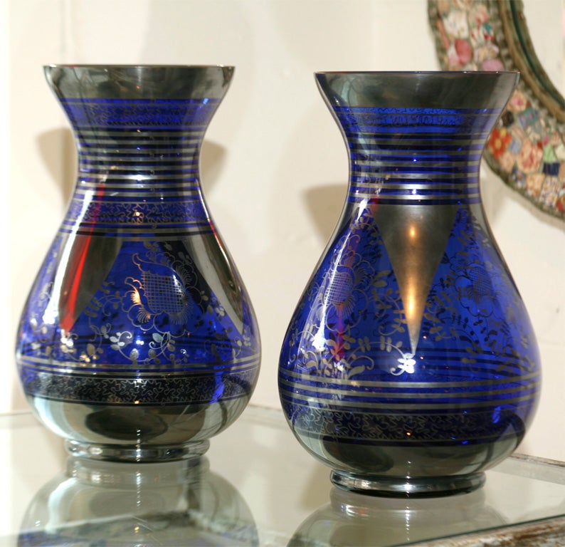 Beautifully designed cobalt blue glass vases with silver overlay.<br />
Floral and striped design. Asymmetrical ( each vase features a unique and complimentary design ).