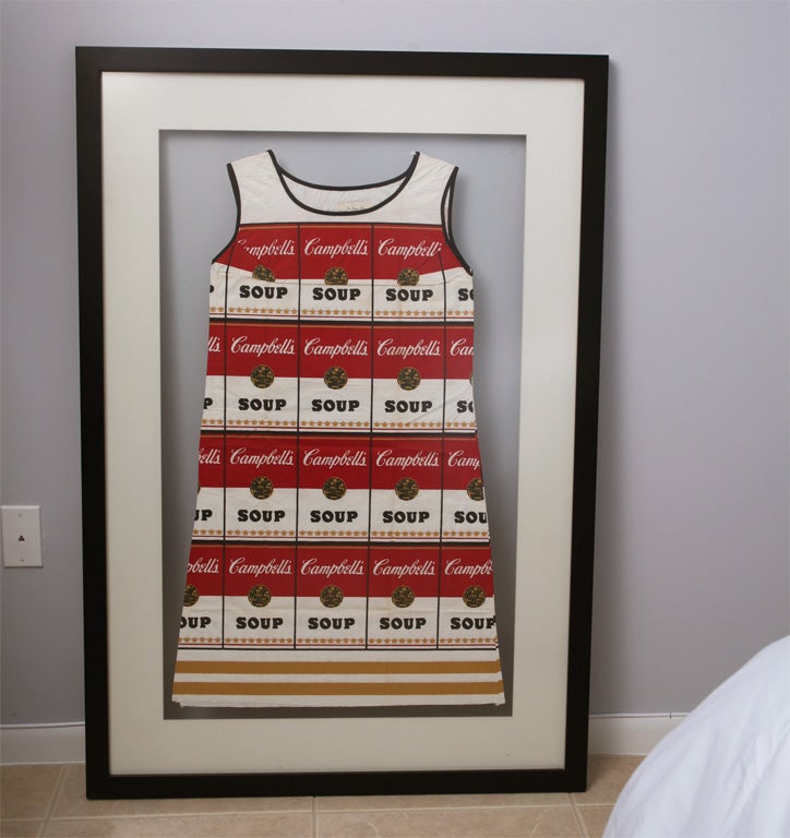 An original Andy Warhol Campbell Soup Can Disposable Dress,size 6, circa 1965. Screen print on paper framed in a transparent Lucite flat box, painted wood frame.
Titled on an original label @ collar, 38