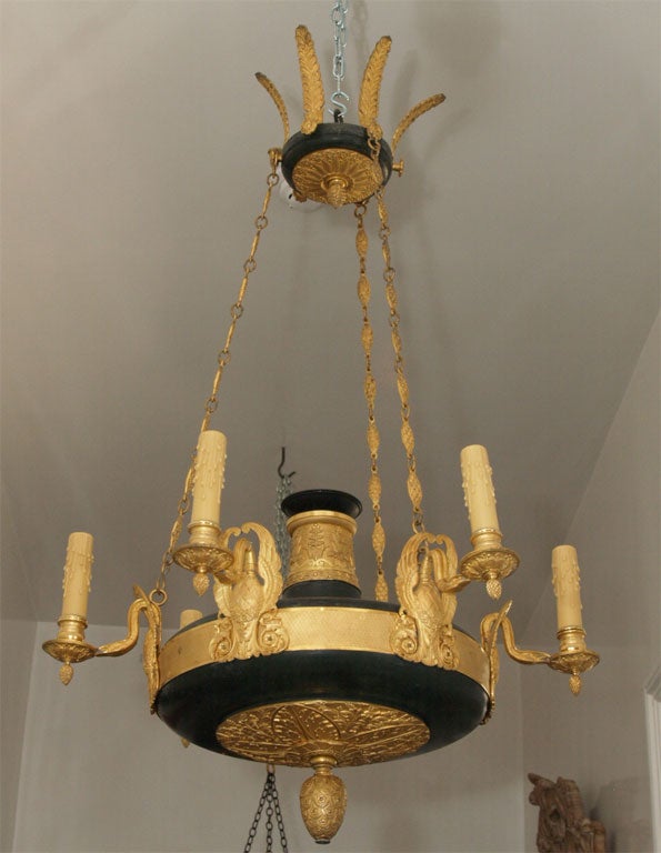 Blackened bronze and gilt bronze mounts depicting birds with wings and feathers at top, six lights.