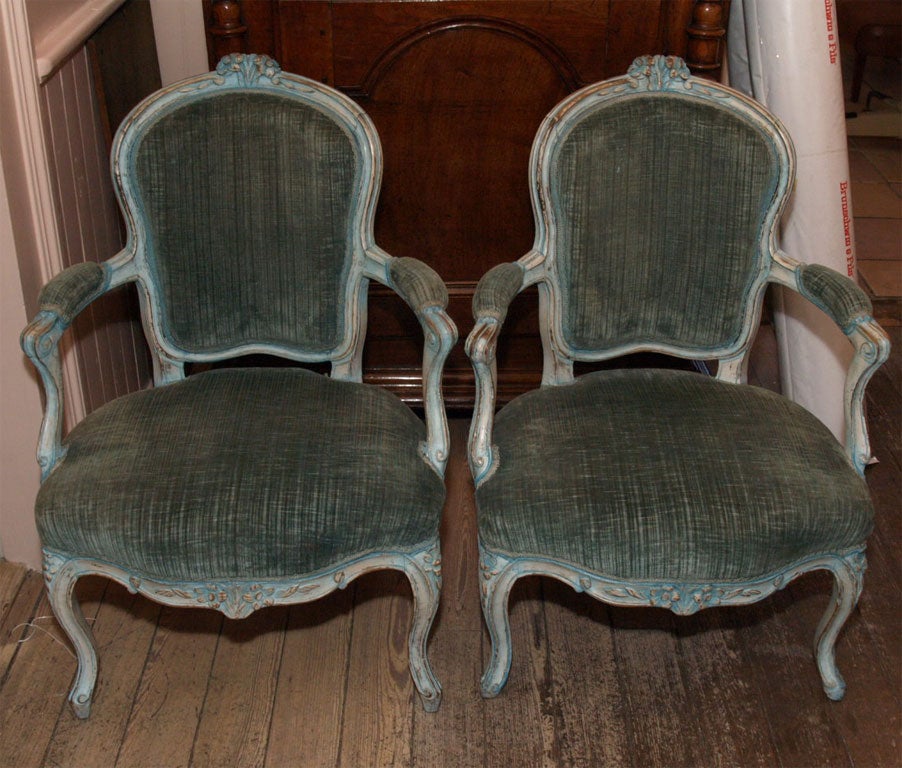 Painted Blue Green in Color with Blue Green Corduroy upholstery. Carved flowers on top crest of chairs.