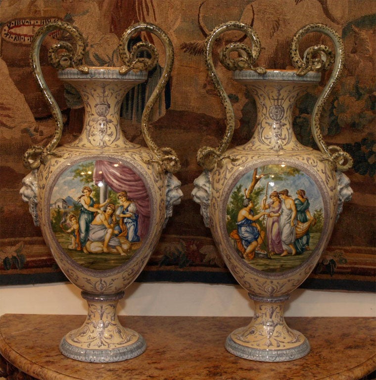 Monumental Pair of Italian faience vase. Handpainted with different scenes on each vase as well as the reverse.