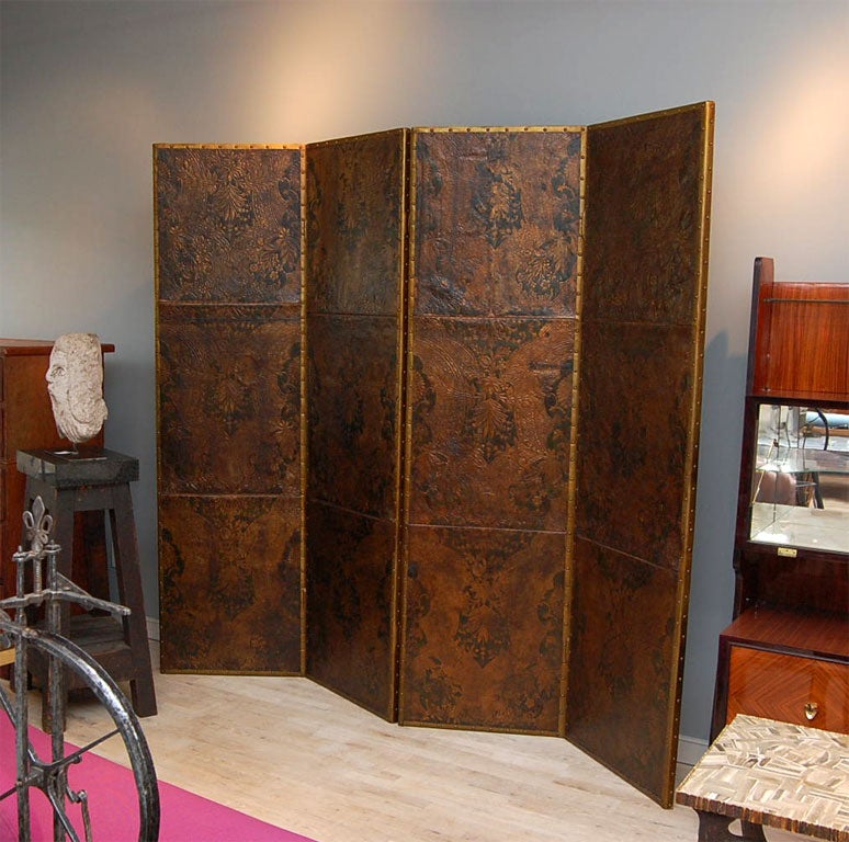 A stunning screen made from panels of 18th century leather. All edges are covered in gold metallic leather with nailheads.