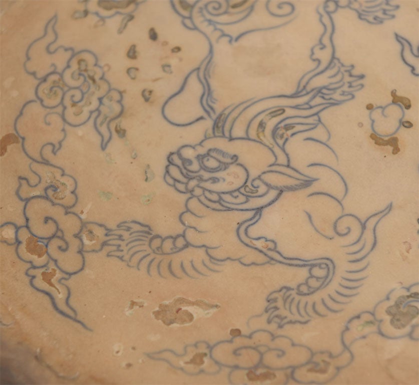 The shallow bowl with a center dragon motif in cobalt blue glaze; recovered from a ship wreck near the ancient trading post of Hoi An; originating from the kilns of the Red River Delta; retaining official stamp from the Hoi An Hoard Vessel on bottom