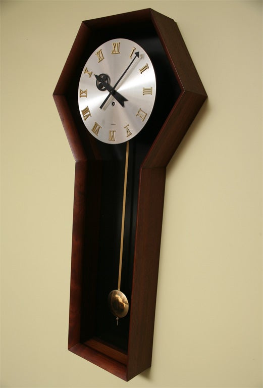 ..SOLD JULY 2011...Swanky walnut cased George Nelson Pendulum Clock for Howard Miller.  Model #557 featuring a brushed metal face and gold Roman numerals with black hands.  Signed Meridian on the face.  Black panelled back inside the shadowbox