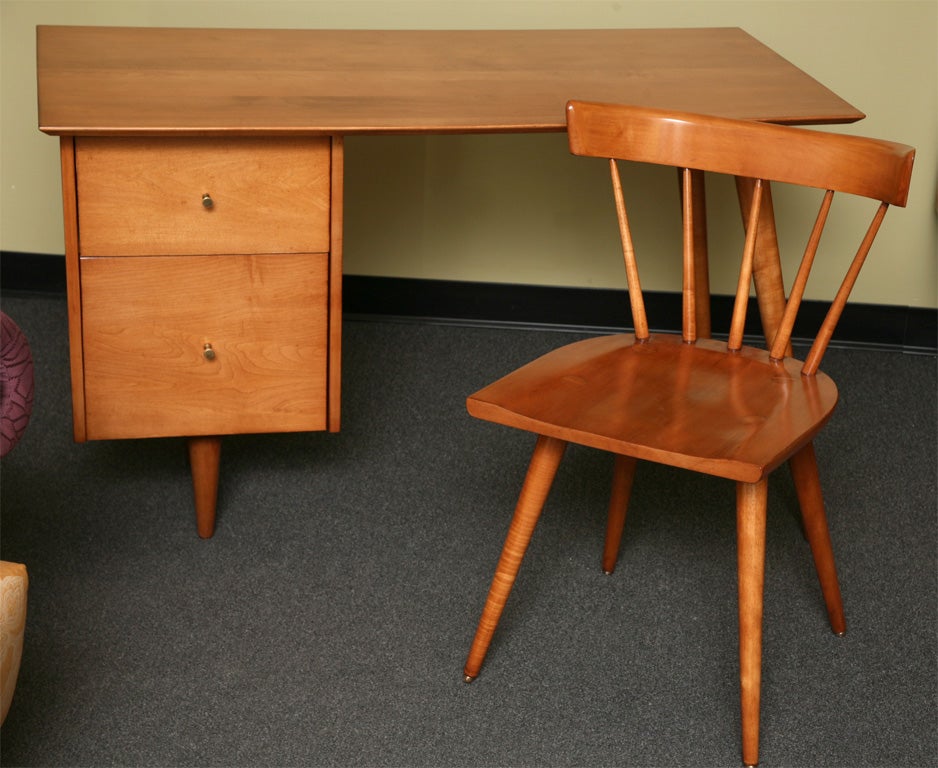 SOLD SEPT 09 From Paul McCobb's Planner Group Line for Winchendon, this solid maple iconic 50's desk is a delight along with the original desk chair.  Two drawers with brass pulls.  All pristinely restored.  Price is for the desk & chair.
