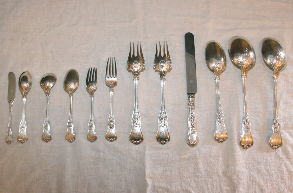 An exquisite set of antique Tiffany flatware in the olympian pattern.  Comprised of 18 tablespoons, 17 dinner forks, 17 dinner knives, 17 teaspoons, 9 salad forks, 10 butter spreaders, 12 grapefruit spoons and 18 dessert spoons.