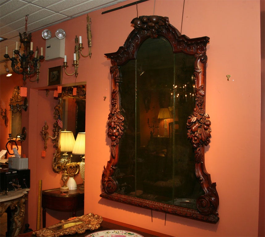 German Elaborately carved mirror with fruits, flowers and leafs and original glass panes.