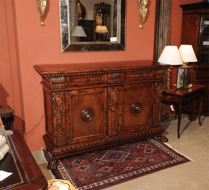 A decorative Baroque style walnut credenza incorporating 18th century elements remounted in the 19th century.