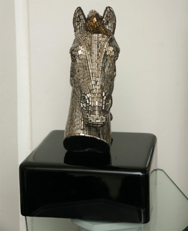 Tiny bits of silver and gold glass tile add even more drama to an already glamorous horse head. Mounted on a black lacquered wood base.