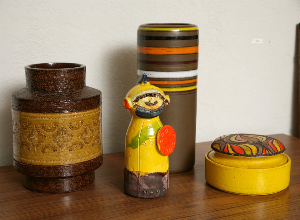 Collection of Bitossi and Raymor pottery, imported for Rosenthal-Netter, consists of two vases, one lidded container, and a whimsical gladiator...all in cheery orange and yellow. Sold together or separately. Call for prices and measurements.