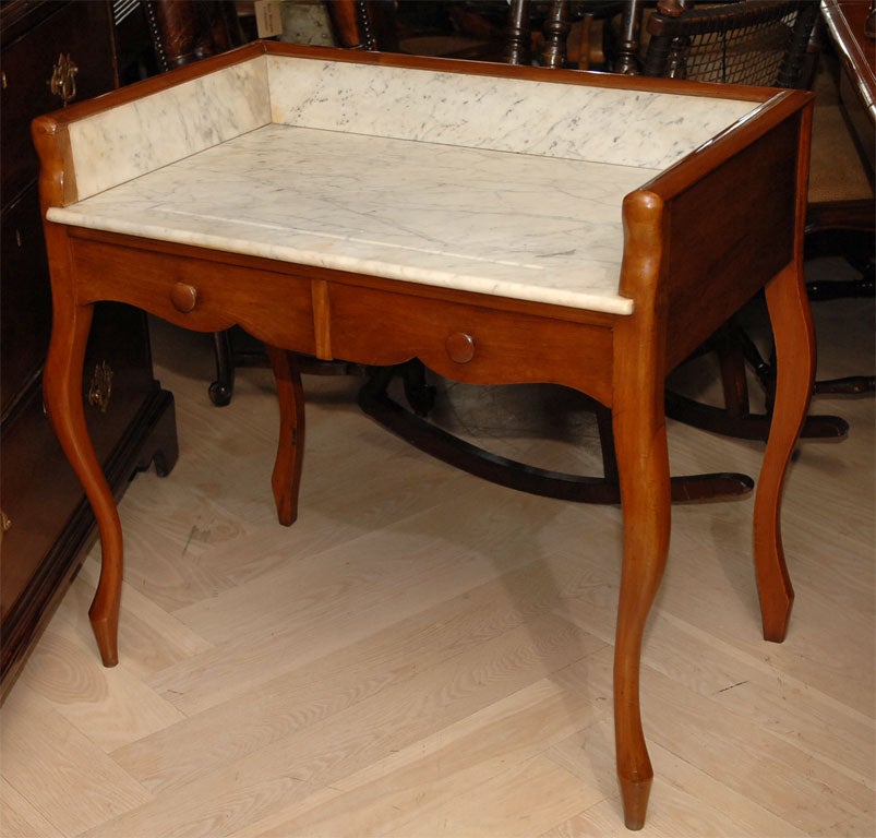 French fruitwood wash stand with white marble top, circa 1870.