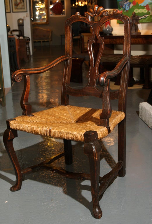 A charming English oak armchair in the French style with rush seat.