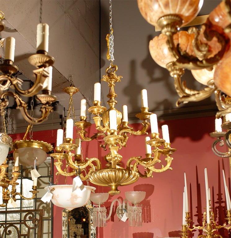Beautiful gilt bronze two-tiered Regence style chandelier having 12 lights.