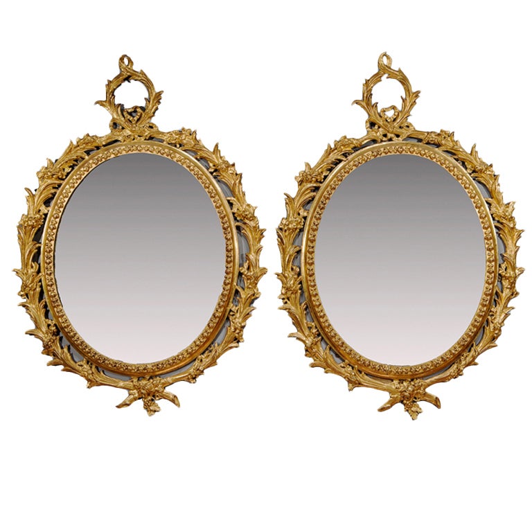 Pair of George III "Carton Pierre" Oval Gilt Mirrors
