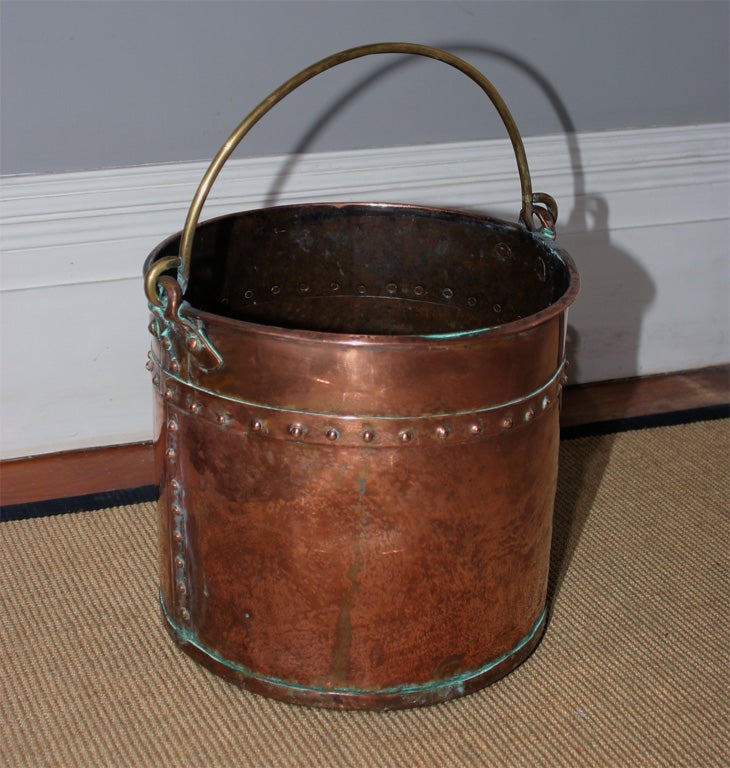 A fine Cotswold circular copper bucket with brass handles and riveted construction. c. 1830.