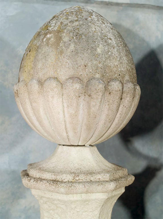 A magnificent and rare pair of hand-carved Portland Stone acorn finials with octagonal bases used to top tall stone gate piers at the entrance to a substantial country estate in Norfolk, England.  Truly an elegant and impressive addition to the