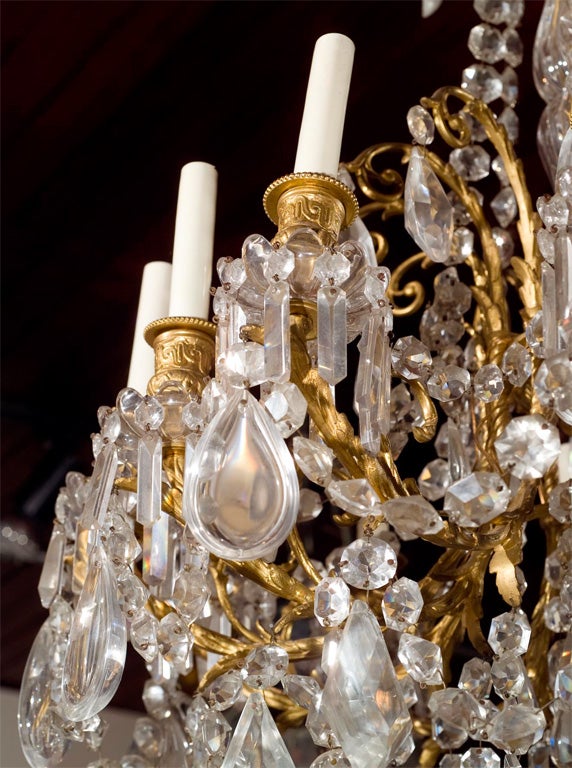 a 12 arm  bronze and crystal chandelier in the Louis  XVI style