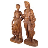a  pair of carved oak or chestnut provincial figures