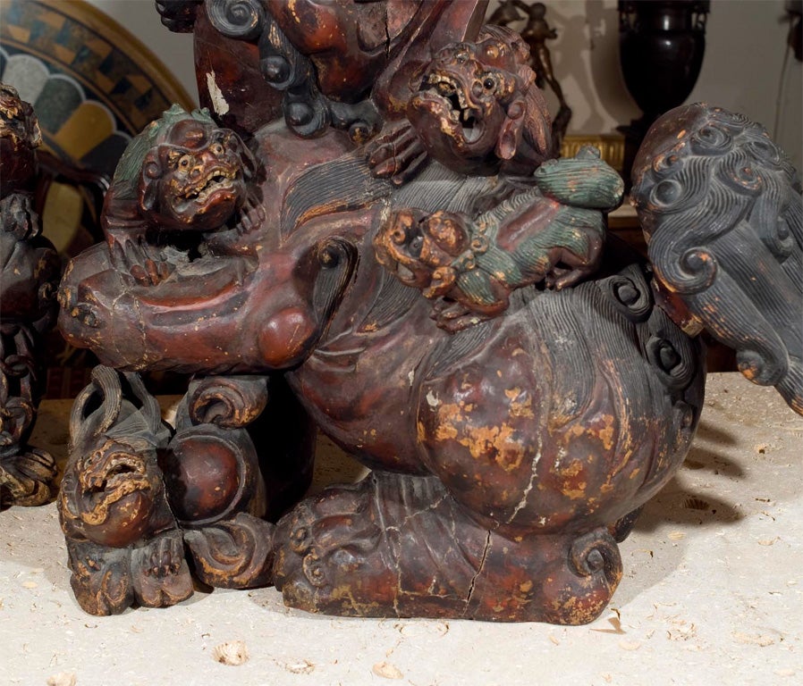 Chinese Pair lacquered, painted over gesso, carved wood Foo dogs