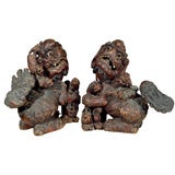 Pair lacquered, painted over gesso, carved wood Foo dogs