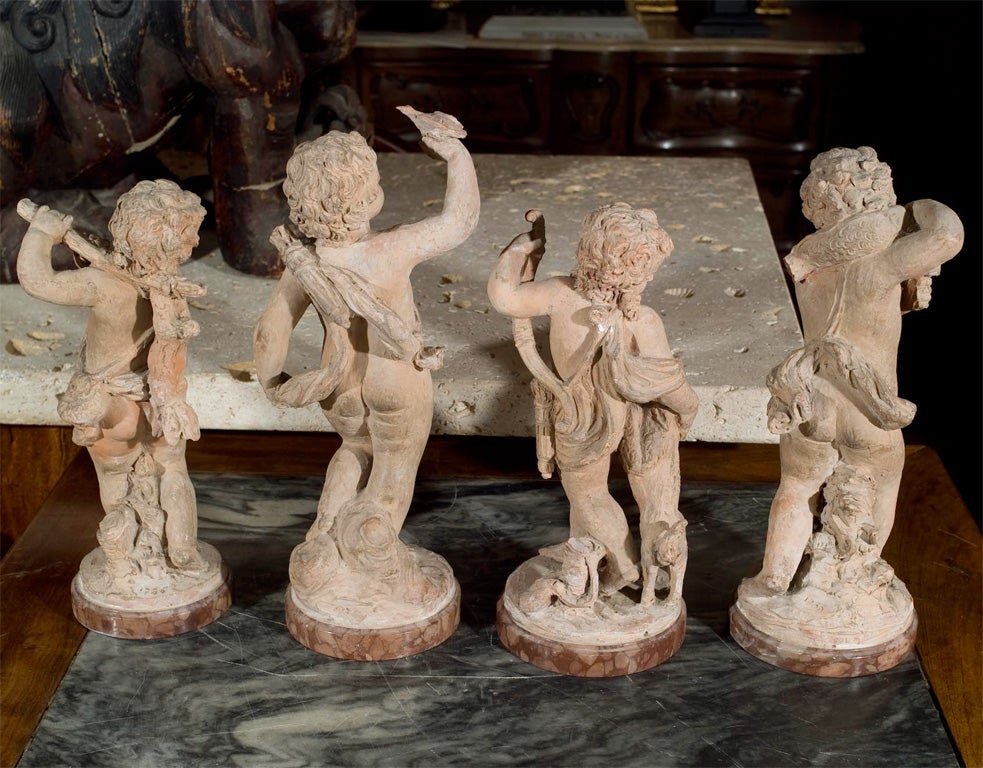 a  group of French terracotta putti 2