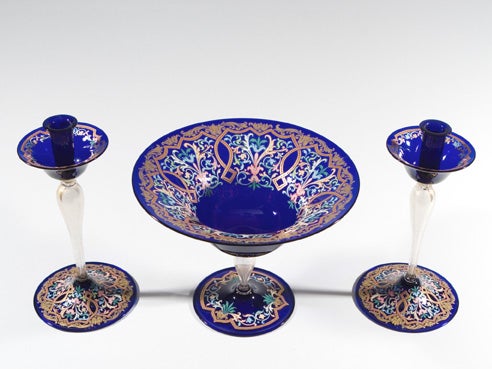 Three-piece Venetian glass centerpiece set with matching candlesticks. The stems having gold leaf inclusions, cobalt candleholders and foot with hand-painted gold enamel and elaborate polychrome 