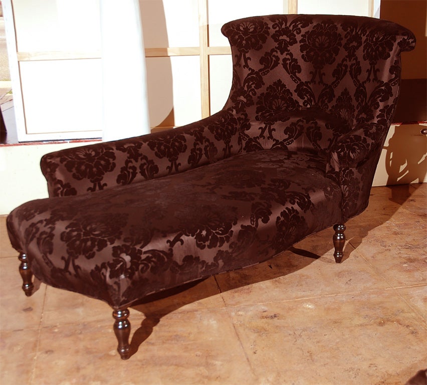 Curved Chaise Lounge with button back and carved Wood legs in Black on Black patten fabric.