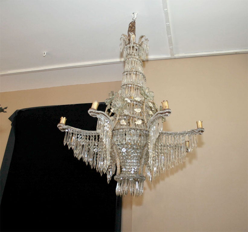 A French gilt metacl chandelier with beaded crystals on body. The body in a tapering shape, with crystal beads and pendants. Crystal flowers and leaves original gilt finish and patina on body.