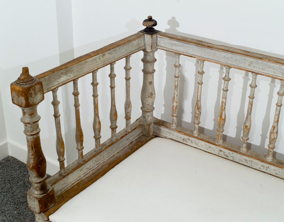1st quarter 19th c Swedish Gustavian pine bench / bed with original grey and black paint. Wonderful spindle back and sides with hand carved reeding on front and fluted feet.  Seat lifts up and front pulls out to reveal trundle bed underneath, super
