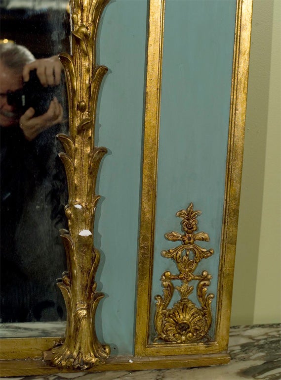 Spectacular palace sized, gilt wood trumeau mirror from the early 20th century. Stamped Jansen. Wonderfully paint decorated with Gilt Gold Hi lights. Fine Carvings.