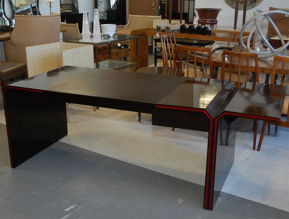 Pierre Paulin desk with Macassar veneered and leather top. Seven sides with red lacquer stripe detail.